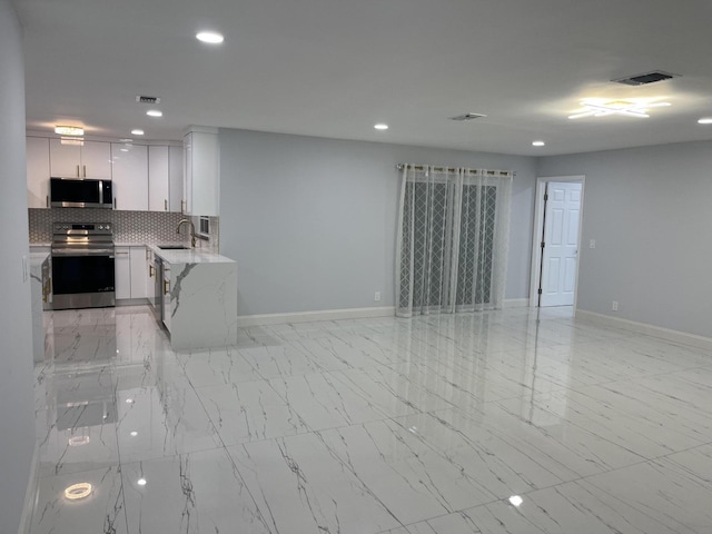 1720 SW 13th St, Boca Raton, FL 33486 - kitchen with appliances with stainless steel finishes, a sink, baseboards, recessed lighting, and light stone counters