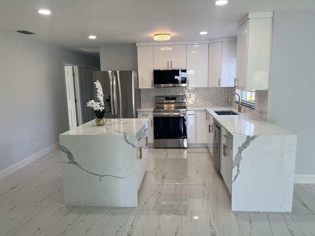 1720 SW 13th St, Boca Raton, FL 33486 - kitchen with appliances with stainless steel finishes, a sink, baseboards, light marble finish flooring, and recessed lighting