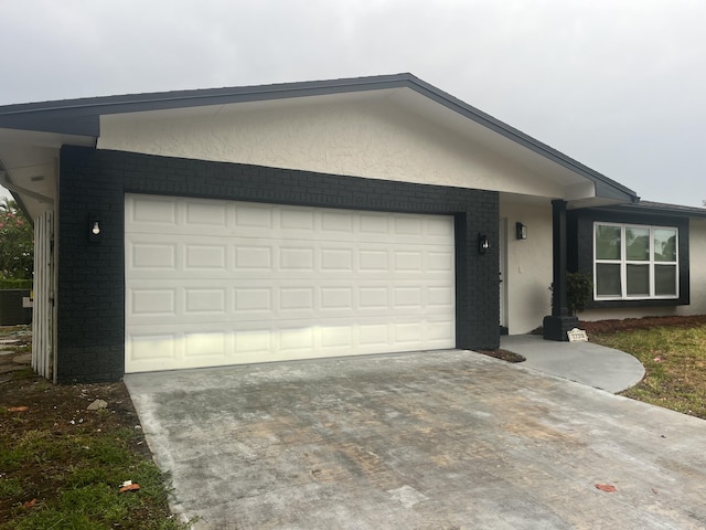 1720 SW 13th St, Boca Raton, FL 33486 - ranch-style home with driveway, an attached garage, stucco siding, and brick siding