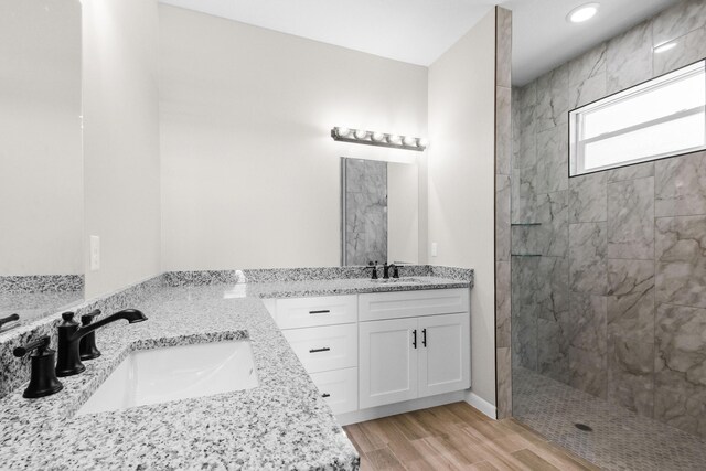 3269 NW 24th Ave, Okeechobee, FL 34972 - full bath with double vanity, a walk in shower, wood finished floors, and recessed lighting