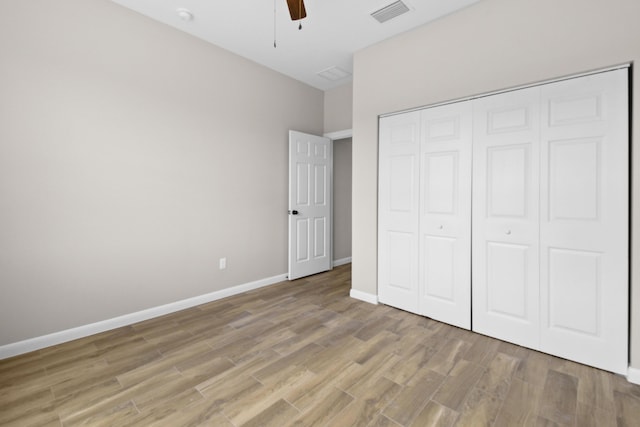 3269 NW 24th Ave, Okeechobee, FL 34972 - unfurnished bedroom featuring light wood-style floors, baseboards, a closet, and a ceiling fan
