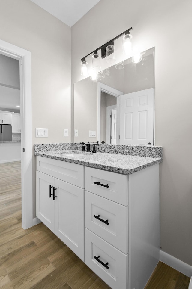 3269 NW 24th Ave, Okeechobee, FL 34972 - bathroom with wood finished floors, baseboards, and vanity