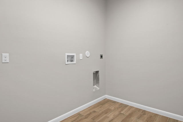 3269 NW 24th Ave, Okeechobee, FL 34972 - washroom featuring electric dryer hookup, baseboards, hookup for a washing machine, light wood-style floors, and hookup for a gas dryer