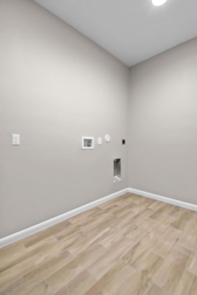 3269 NW 24th Ave, Okeechobee, FL 34972 - clothes washing area with electric dryer hookup, washer hookup, baseboards, and light wood-type flooring