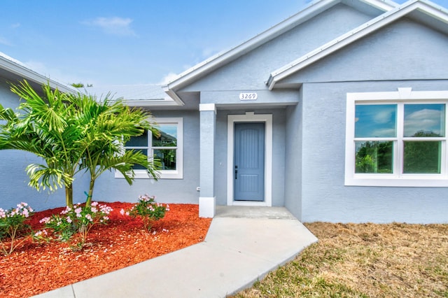 3269 NW 24th Ave, Okeechobee, FL 34972 - doorway to property featuring stucco siding