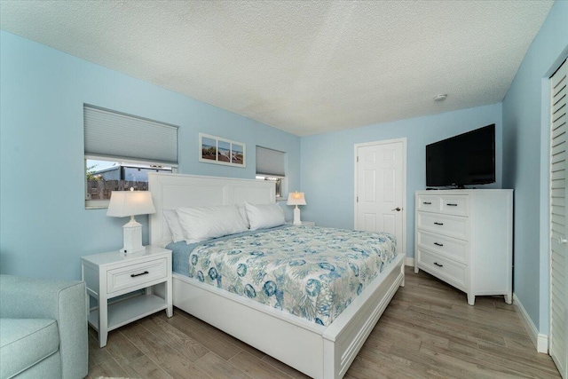 71 S Las Olas Dr, Jensen Beach, FL 34957 - bedroom with wood finished floors, a textured ceiling, and baseboards