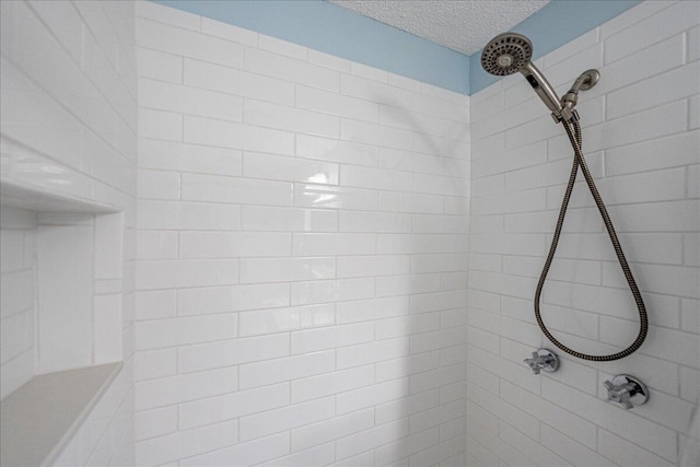 71 S Las Olas Dr, Jensen Beach, FL 34957 - bathroom view of a tile shower and a textured ceiling