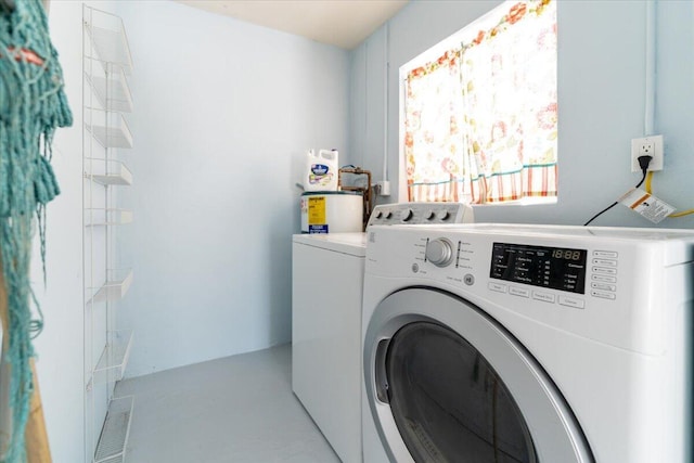 71 S Las Olas Dr, Jensen Beach, FL 34957 - laundry room featuring washer and clothes dryer and water heater