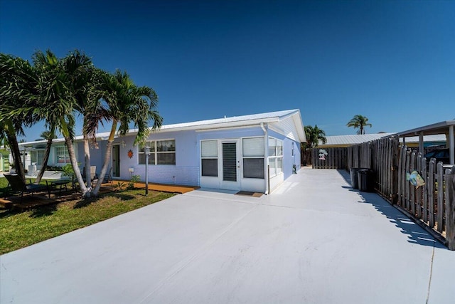 71 S Las Olas Dr, Jensen Beach, FL 34957 - view of front of home featuring fence and driveway