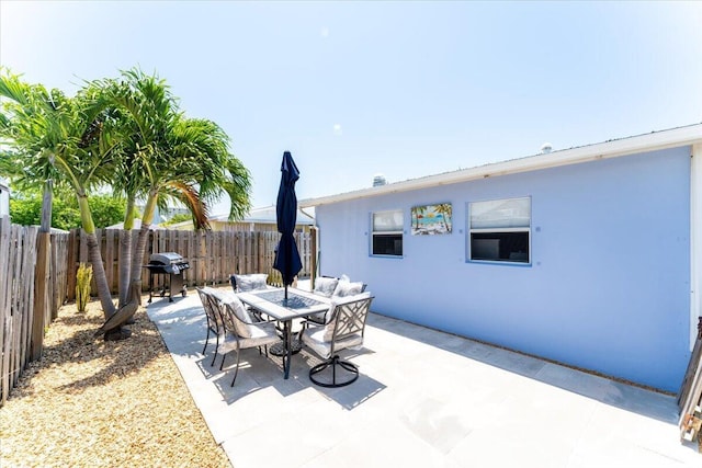 71 S Las Olas Dr, Jensen Beach, FL 34957 - view of patio with a fenced backyard and outdoor dining space