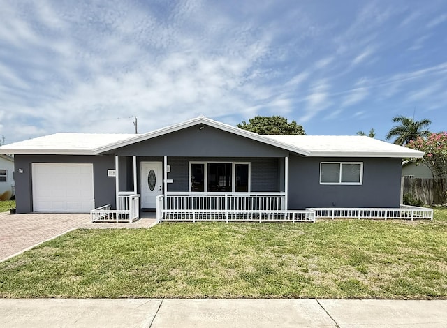 257 SW 5th St, Boca Raton, FL 33432 - ranch-style house with a porch, an attached garage, decorative driveway, and a front yard