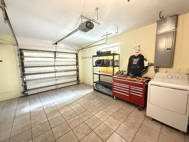 257 SW 5th St, Boca Raton, FL 33432 - garage featuring washer / clothes dryer, a garage door opener, and electric panel