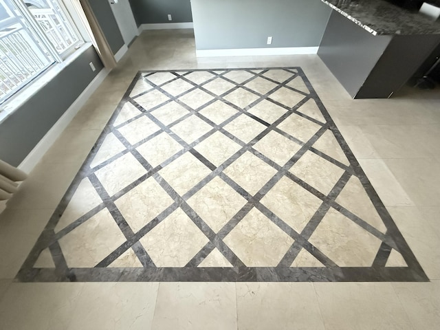 257 SW 5th St, Boca Raton, FL 33432 - unfurnished living room featuring inlaid floor details and baseboards