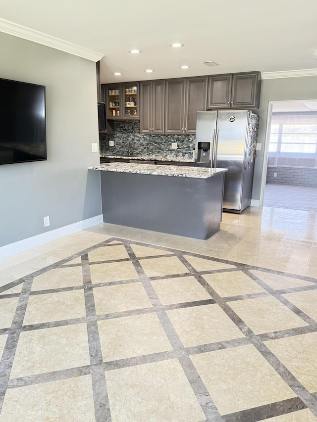 257 SW 5th St, Boca Raton, FL 33432 - kitchen featuring stainless steel fridge with ice dispenser, inlaid floor details, crown molding, a peninsula, and glass insert cabinets
