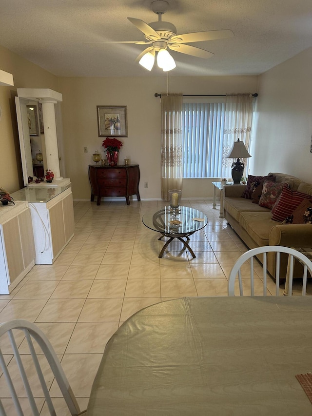 living area with ceiling fan and light tile patterned flooring