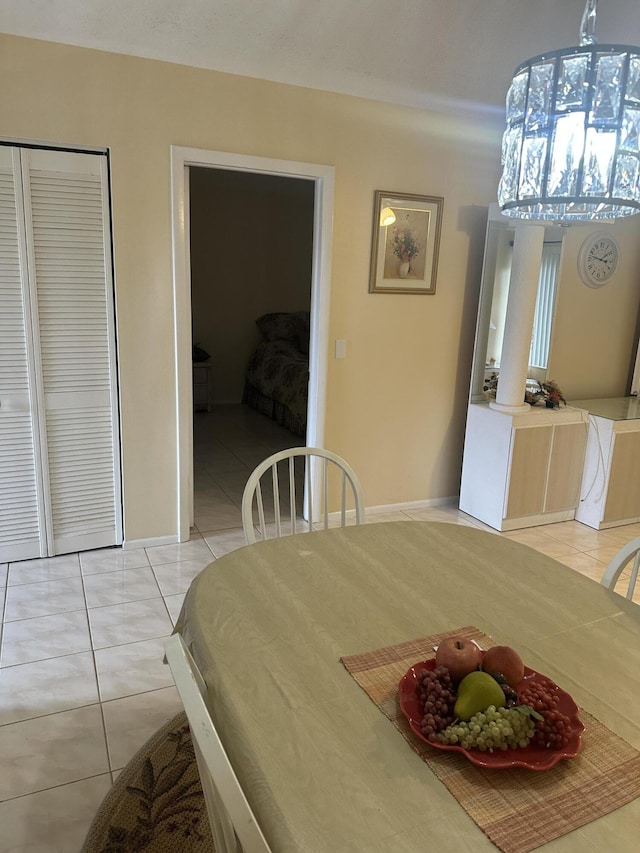 dining space with light tile patterned floors and baseboards