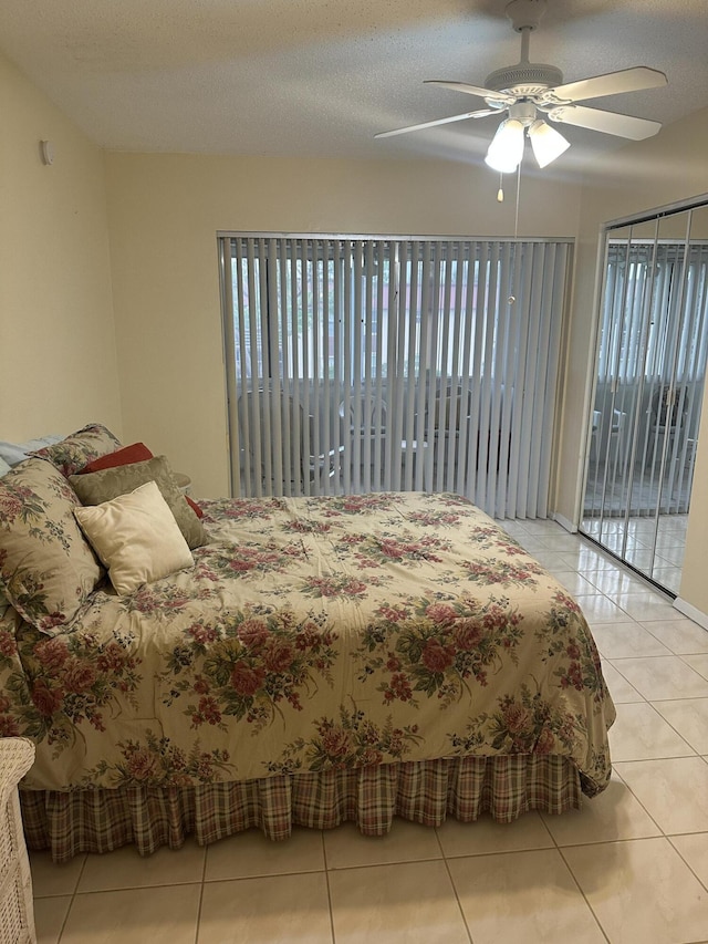 bedroom featuring tile patterned flooring, access to outside, and ceiling fan