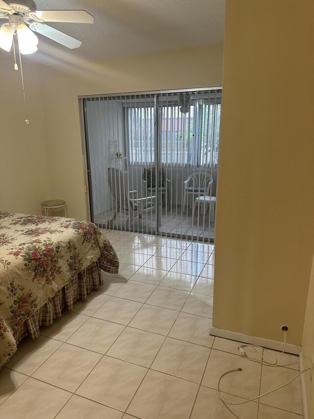 bedroom with light tile patterned floors, access to outside, and a ceiling fan