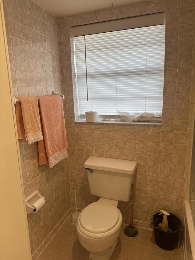 bathroom featuring tile walls, toilet, and tile patterned floors