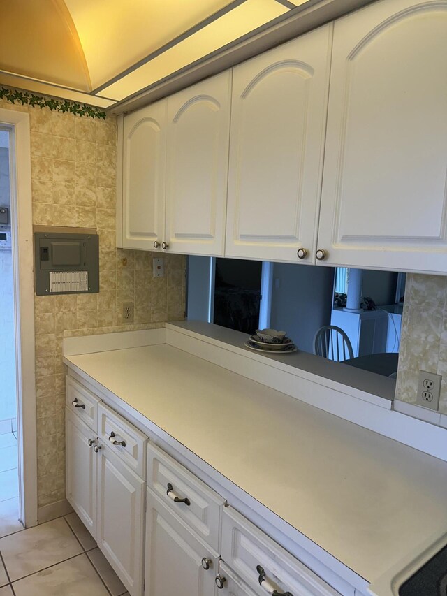 kitchen featuring white cabinets, light tile patterned floors, and light countertops