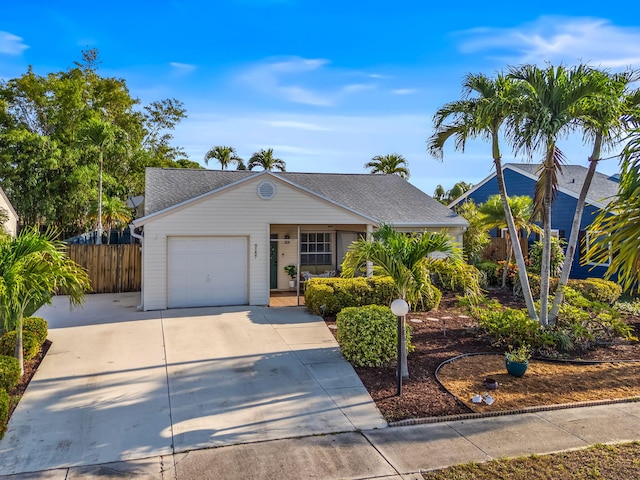 5157 Canal Cir S, Lake Worth, FL 33467 - ranch-style house featuring a garage, fence, concrete driveway, and roof with shingles