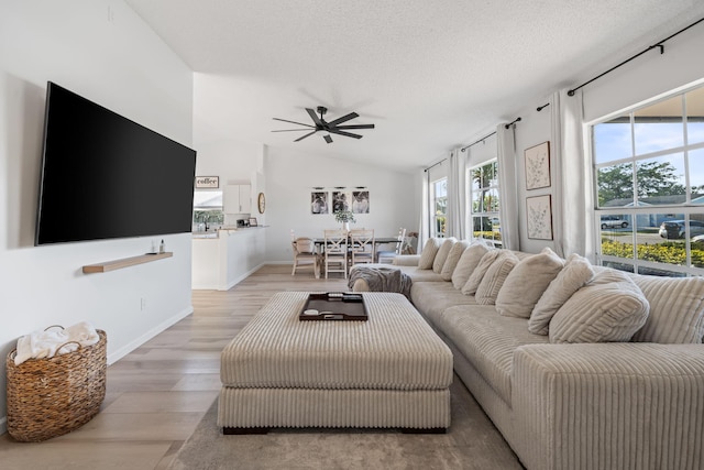 5157 Canal Cir S, Lake Worth, FL 33467 - living area with a ceiling fan, light wood-style floors, a textured ceiling, lofted ceiling, and baseboards