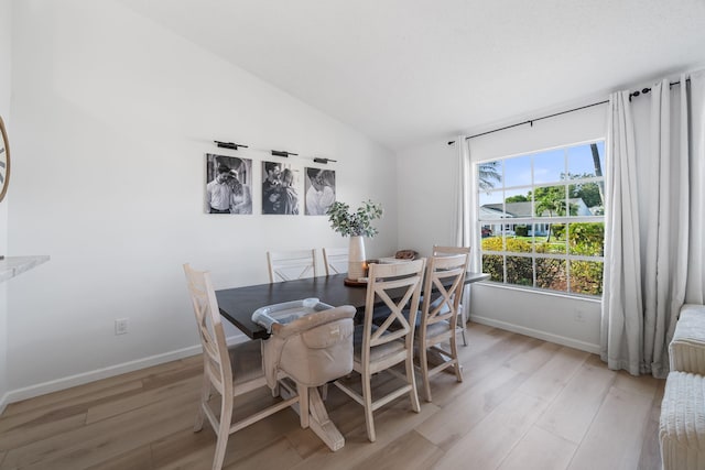 5157 Canal Cir S, Lake Worth, FL 33467 - dining area with light wood-style flooring, lofted ceiling, and baseboards