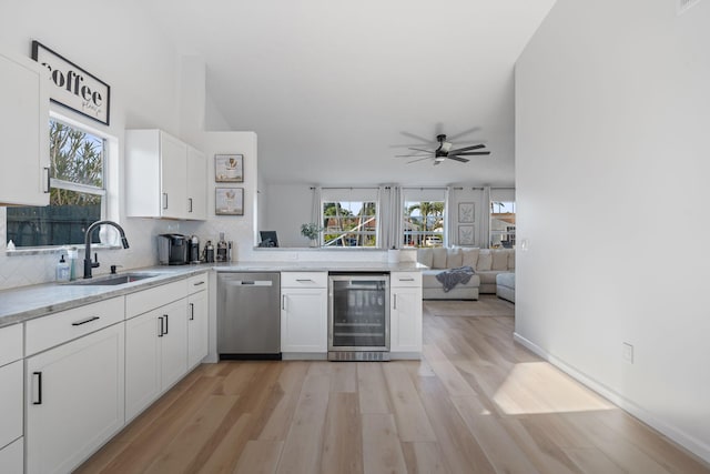 5157 Canal Cir S, Lake Worth, FL 33467 - kitchen featuring beverage cooler, dishwasher, a sink, light wood-style flooring, and white cabinets