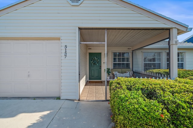 5157 Canal Cir S, Lake Worth, FL 33467 - doorway to property featuring a porch, a garage, and concrete driveway
