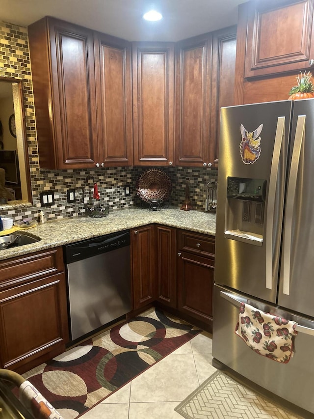 2010 Colonial Rd Unit 3, Fort Pierce, FL 34950 - kitchen featuring appliances with stainless steel finishes, backsplash, light tile patterned floors, and light stone countertops