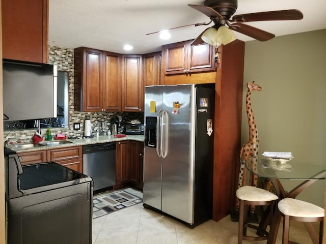 2010 Colonial Rd Unit 3, Fort Pierce, FL 34950 - kitchen with stainless steel appliances, backsplash, ceiling fan, light stone countertops, and a sink