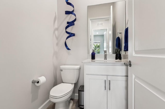 822 Hookline Cir, Loxahatchee, FL 33470 - half bathroom featuring vanity, toilet, and baseboards