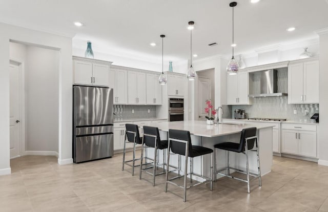 822 Hookline Cir, Loxahatchee, FL 33470 - kitchen with stainless steel appliances, wall chimney range hood, tasteful backsplash, a sink, and light countertops