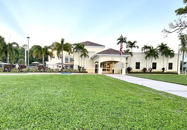 341 Northampton Q, West Palm Beach, FL 33417 - view of front of property with stucco siding, a front yard, and a tiled roof