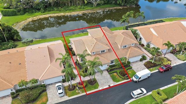 aerial view of property and surrounding area featuring a large body of water and property parcel outlined