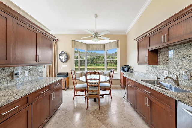 kitchen featuring a sink, crown molding, baseboards, ceiling fan, and decorative backsplash