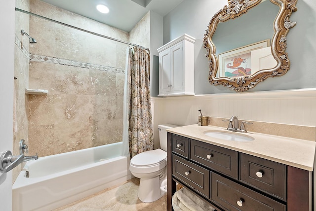 bathroom featuring toilet, shower / bathtub combination with curtain, wainscoting, and vanity