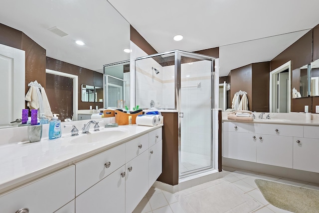 bathroom with a shower stall, tile patterned flooring, vanity, and recessed lighting