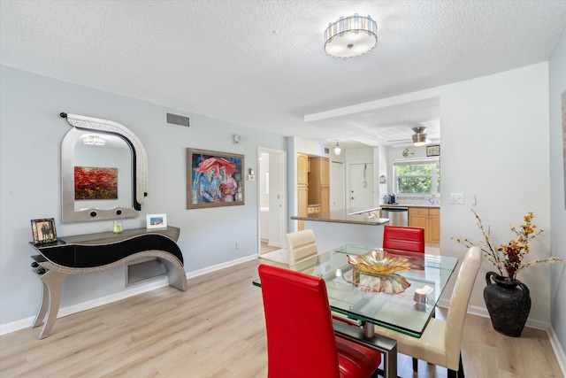 2016 S Federal Hwy Unit 206, Boynton Beach, FL 33435 - dining space with light wood-type flooring, a textured ceiling, a ceiling fan, and baseboards