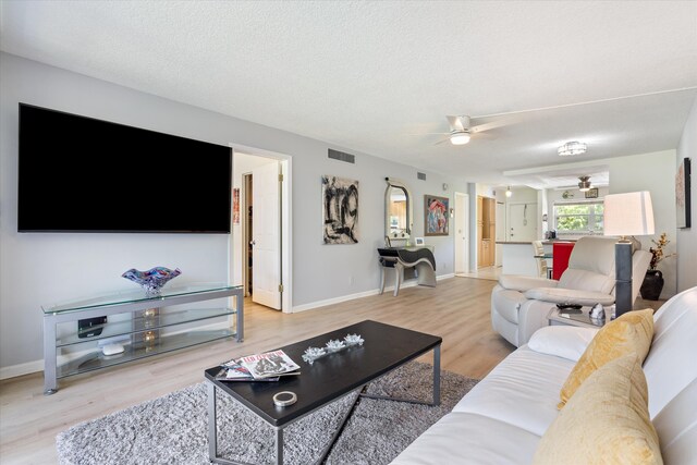 2016 S Federal Hwy Unit 206, Boynton Beach, FL 33435 - living area with ceiling fan, wood finished floors, baseboards, and a textured ceiling