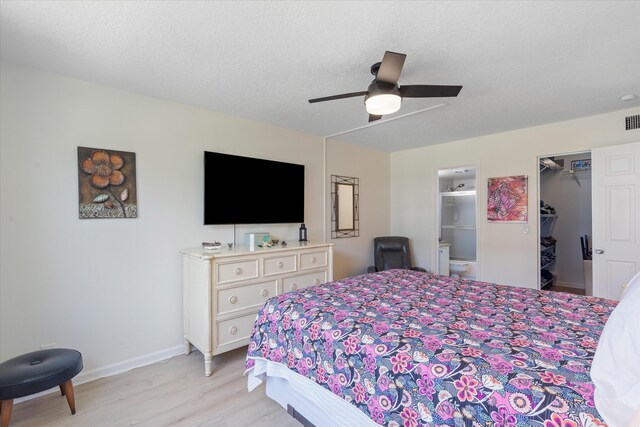 2016 S Federal Hwy Unit 206, Boynton Beach, FL 33435 - bedroom with light wood finished floors, baseboards, ensuite bath, a spacious closet, and ceiling fan