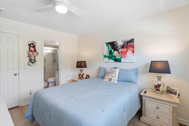 2016 S Federal Hwy Unit 206, Boynton Beach, FL 33435 - bedroom with light wood-type flooring, ensuite bath, a textured ceiling, ceiling fan, and baseboards