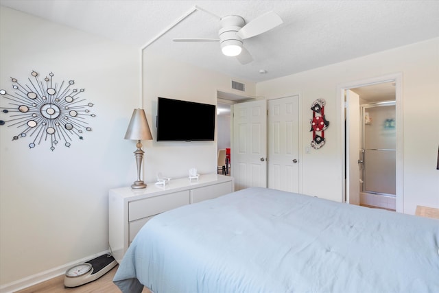 2016 S Federal Hwy Unit 206, Boynton Beach, FL 33435 - bedroom with baseboards, ceiling fan, light wood finished floors, and connected bathroom