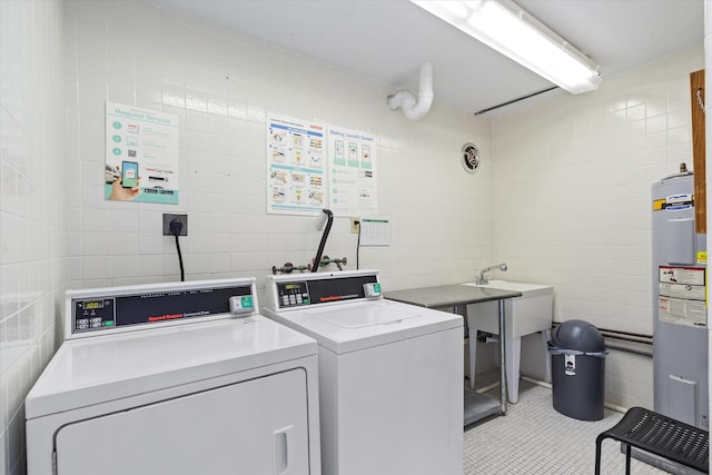 2016 S Federal Hwy Unit 206, Boynton Beach, FL 33435 - shared laundry room with washing machine and dryer, tile walls, electric water heater, and light tile patterned flooring