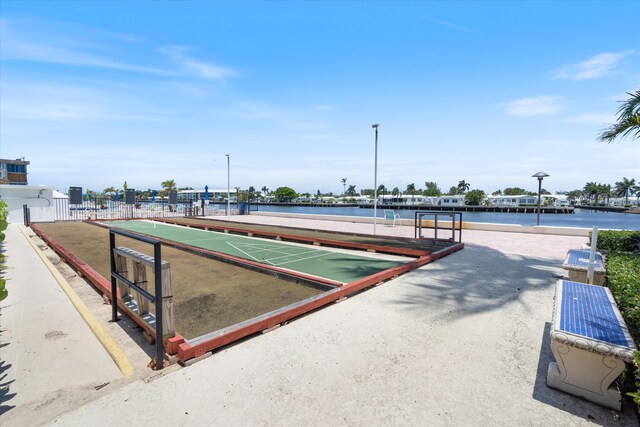 2016 S Federal Hwy Unit 206, Boynton Beach, FL 33435 - view of home's community featuring shuffleboard, a water view, fence, and a bocce ball area