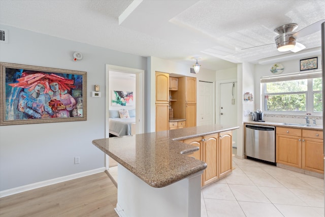 2016 S Federal Hwy Unit 206, Boynton Beach, FL 33435 - kitchen with dishwasher, a sink, a textured ceiling, a center island, and light wood-style flooring