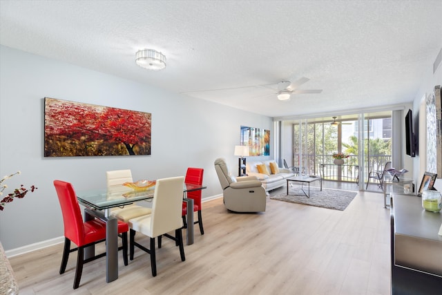 2016 S Federal Hwy Unit 206, Boynton Beach, FL 33435 - dining room featuring a textured ceiling, wood finished floors, ceiling fan, baseboards, and floor to ceiling windows