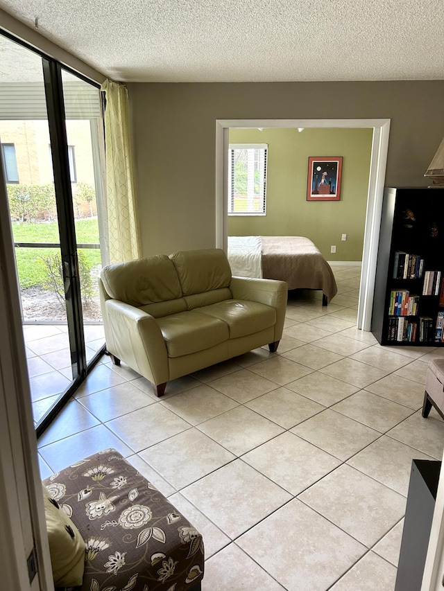 11231 Green Lake Dr Unit 104, Boynton Beach, FL 33437 - living area featuring light tile patterned floors and a textured ceiling