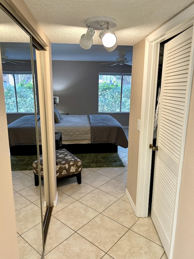 11231 Green Lake Dr Unit 104, Boynton Beach, FL 33437 - bedroom with light tile patterned floors and a textured ceiling