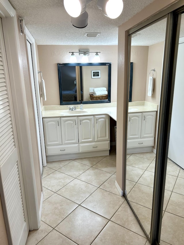 11231 Green Lake Dr Unit 104, Boynton Beach, FL 33437 - full bath with ensuite bathroom, vanity, tile patterned floors, and a textured ceiling